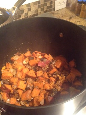 Sautéing the sweet potato, onions, and garlic.